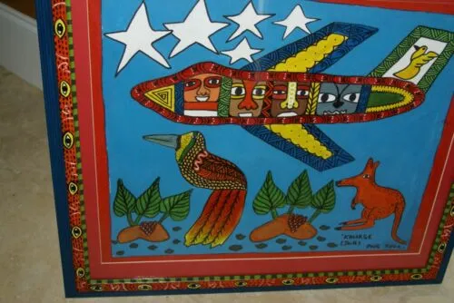 RARE UNIQUE COLORFUL  FOLK ART PAINTING PAPUA NEW GUINEA HUMOROUS ARTIST: TRIBAL WARRIORS TRAVELLING BY AIRPLANE & FRAMED IN SIGNED HAND PAINTED FRAME TO MATCH THE ART DESIGNER COLLECTOR WALL CARTOON  ART  26 1/2” by 23 1/2” HUGE DFP8